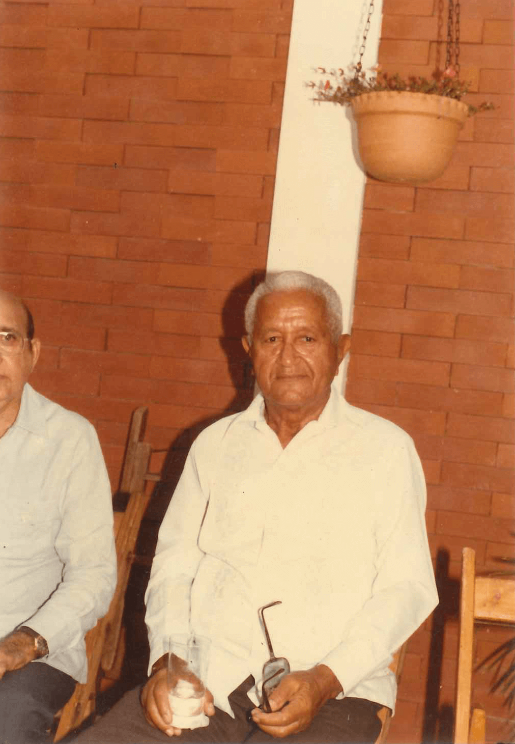 the grandfather of the founder of Camilo's Chocolate sitting in a chair